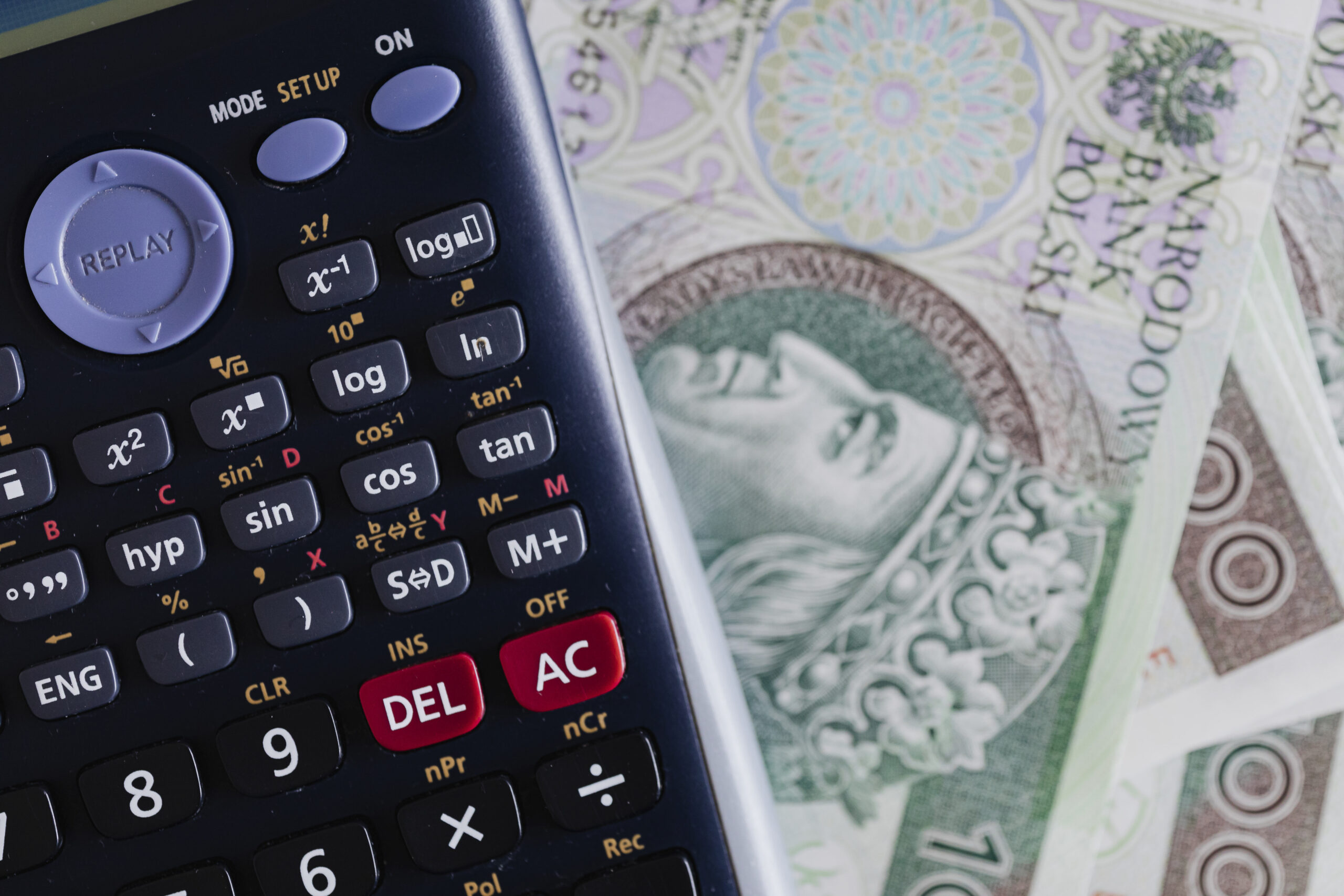 Calculator and Polish Zloty currency banknotes on a table